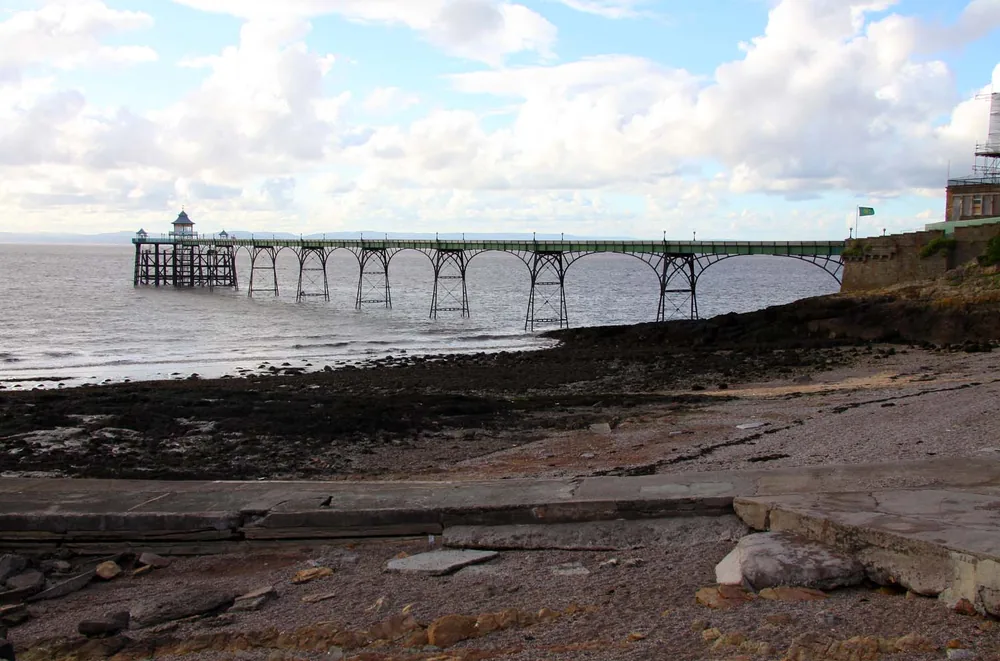 Clevedon Pier stretching across the water from the rocky shoreline