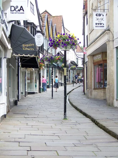 Cheap Street in Frome, with historic shopfronts and the leat running along the street
