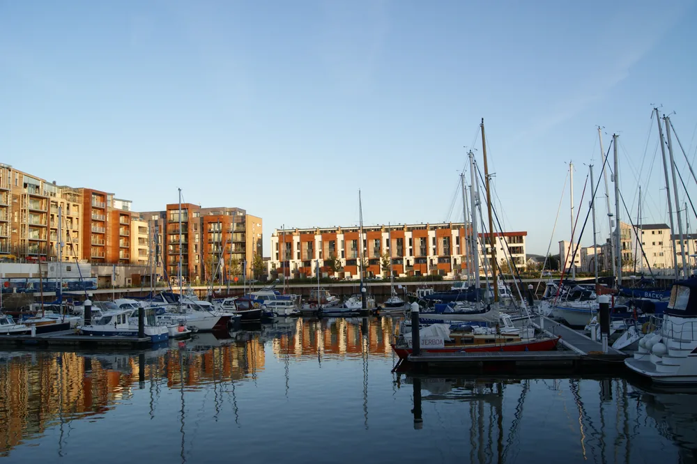 Boats moored at Portishead Marina, with waterfront buildings behind them